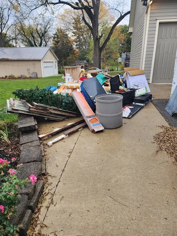 Dumpster being loaded with debris for Estate Cleanout Dumpster Rental in Brecknock